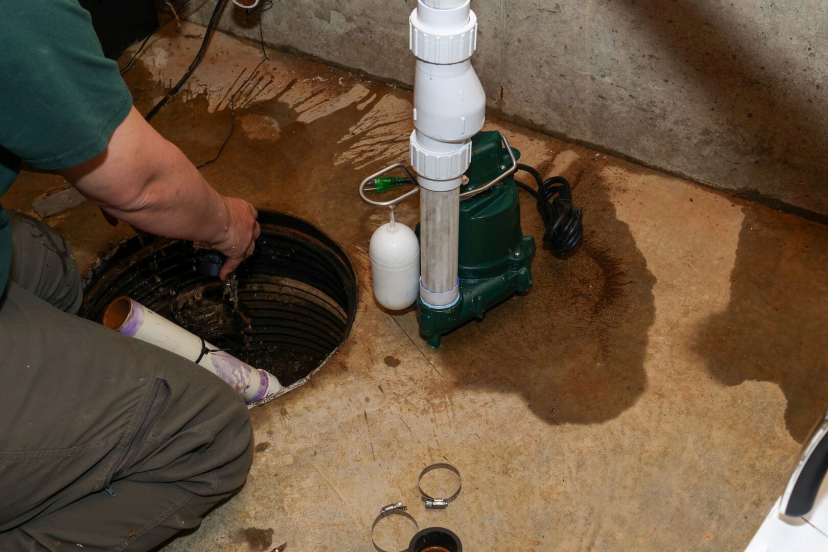 Installing a sump pump in a basement.