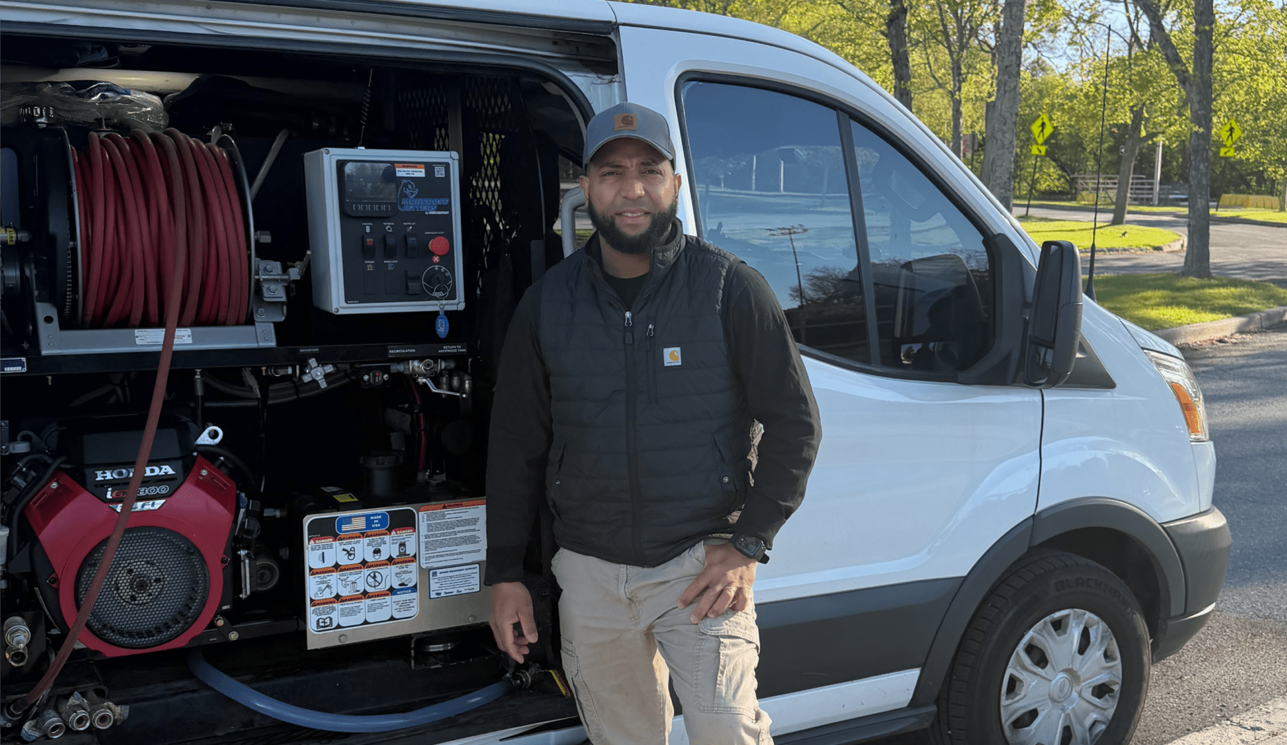Technician standing beside open service van equipment