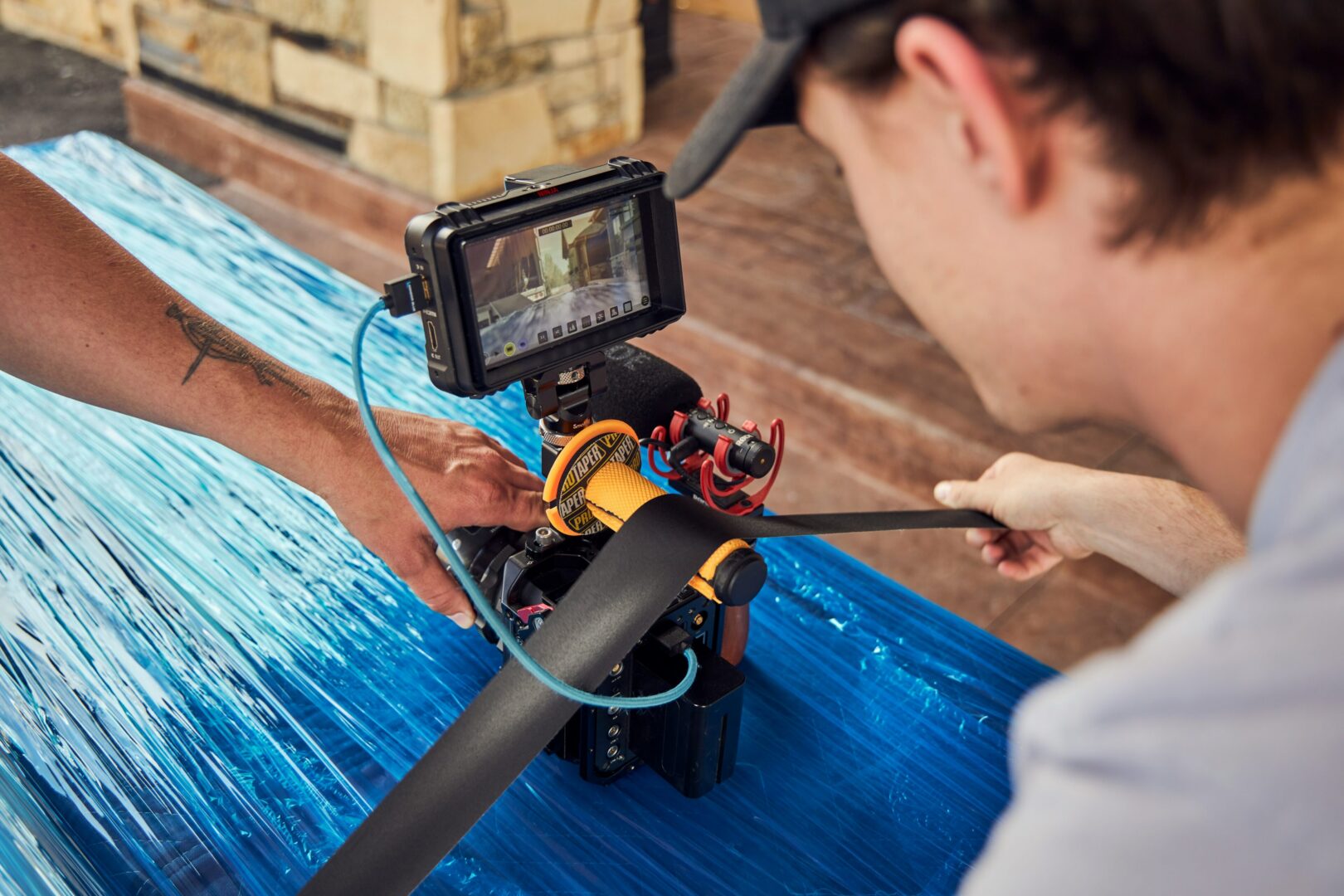 Filmmaker setting up camera with monitor