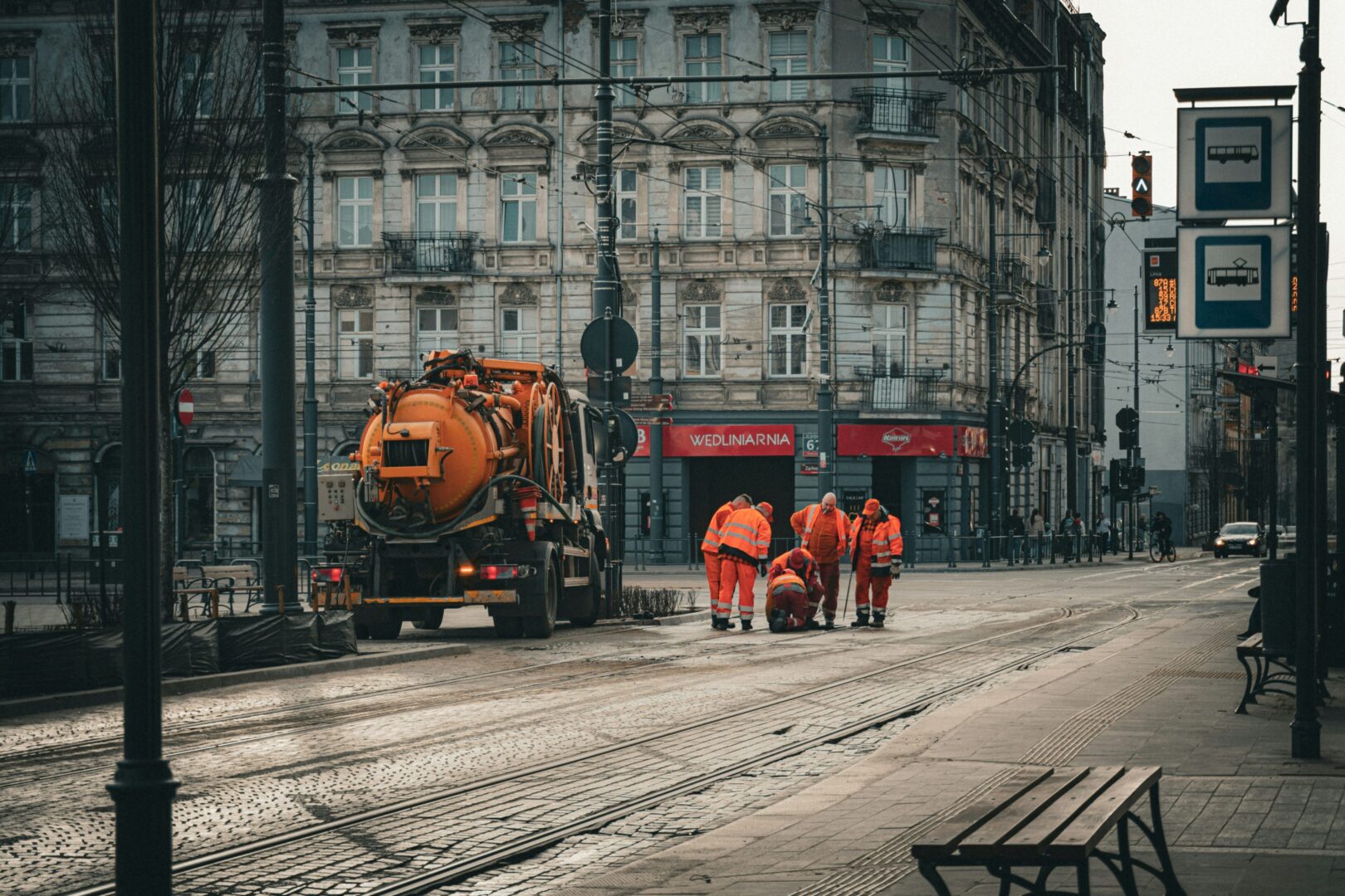 Workers repairing road with equipment truck