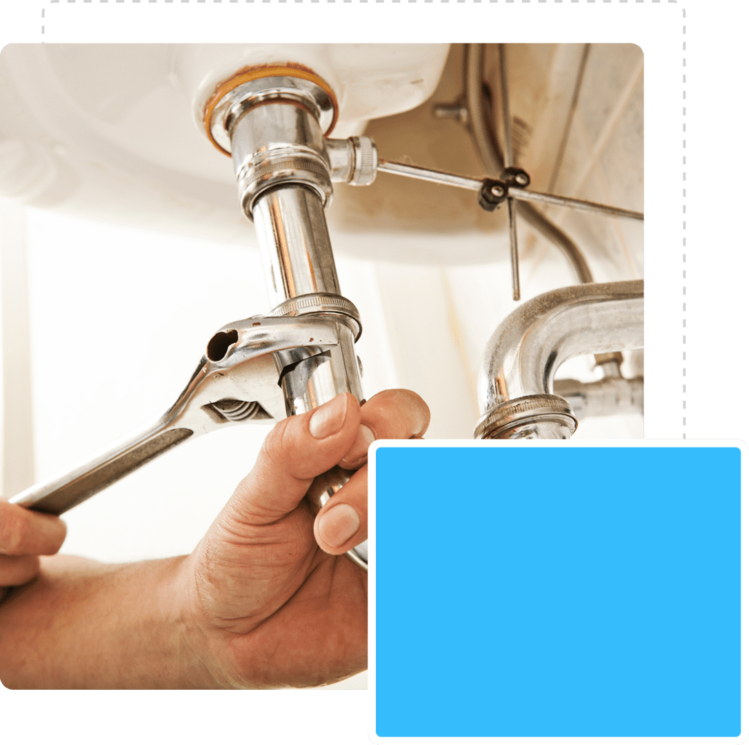Hands fixing sink pipe with wrench.
